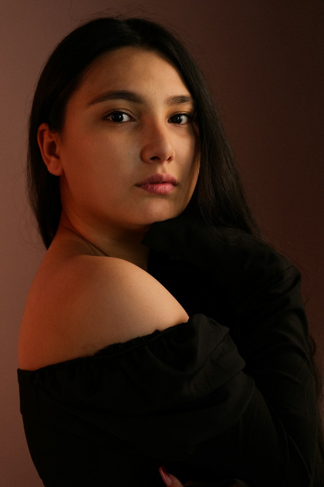 Studio portrait of a young woman with dark hair