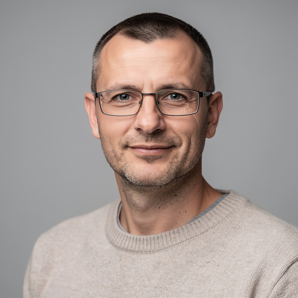 Studio portrait of a man with glasses
