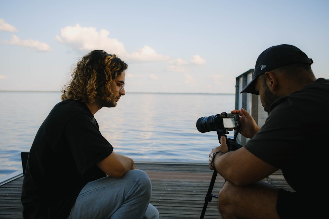 Two people recording a seated interview on camera